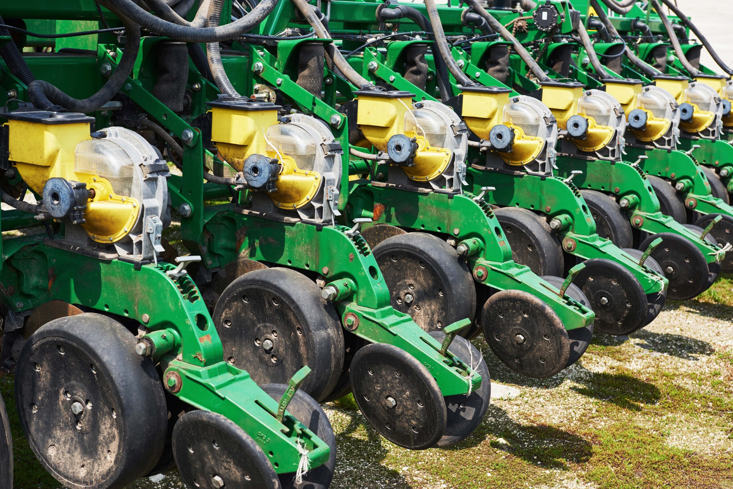 close-up-seeder-attached-tractor-field-min